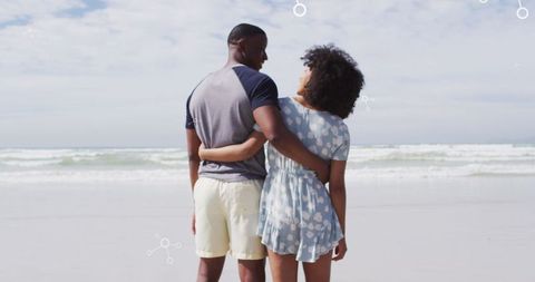 Couple Embracing at Beach with Molecular Design Overlay