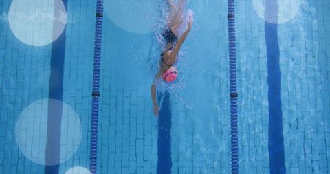 Female Swimmer Gliding Through Pool Lane in Active Stance