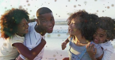 Joyful Family Playing Together on Sunlit Beach with Ocean Waves