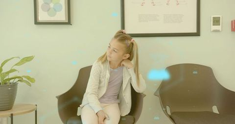 Young girl waiting in modern clinic reception with thoughtful expression
