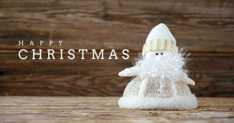 Christmas Greeting with Plush Santa Claus on Rustic Background