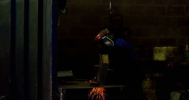 Worker Shaping Metal with Hand Grinder in Foundry Workshop - Download Free Stock Images Pikwizard.com