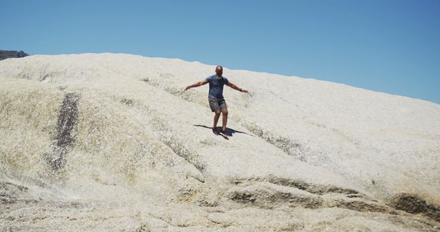 Man Exploring Rocky Terrain on a Sunny Day - Download Free Stock Images Pikwizard.com