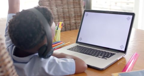 Young Boy Using Laptop for Online Learning with Headphones at Home - Download Free Stock Images Pikwizard.com