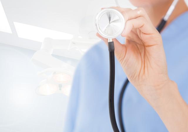 Female doctor holding stethoscope in a hospital setting. Ideal for healthcare, medical, and wellness-related content. Useful for illustrating medical services, patient care, and professional healthcare environments.