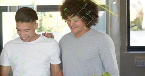Smiling young men exploring augmented reality interface in bright modern apartment