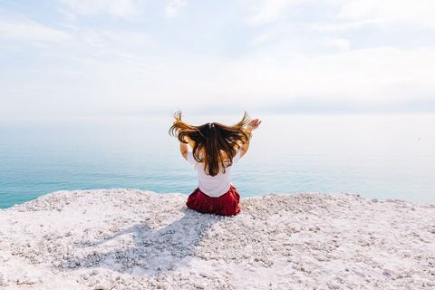 Woman enjoying freedom by the sea