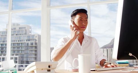 Asian Businessman in Bright Office on Phone Call - Download Free Stock Images Pikwizard.com