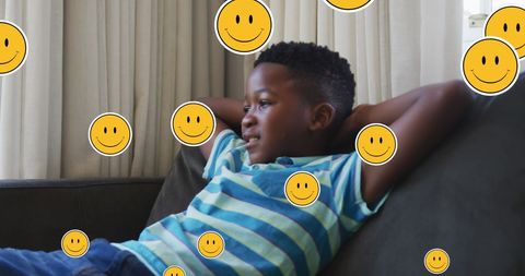 Happy Boy Relaxing with Emojis in Living Room