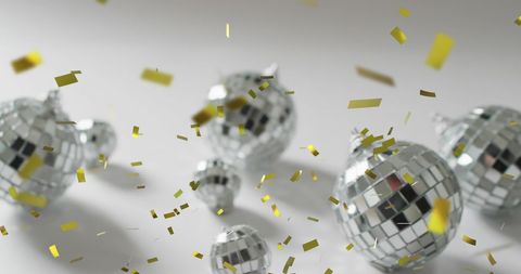 Festive celebration with silver disco balls and gold confetti