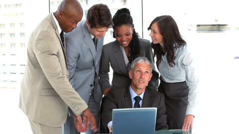 Diverse Business Team Collaborating With Laptops in Bright Office