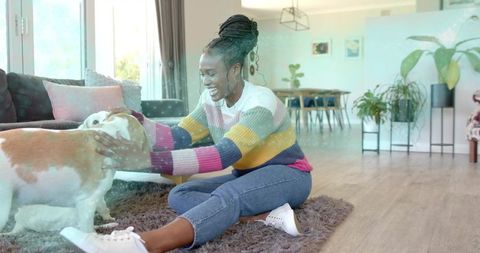 Joyful Woman Playing with Her Pet Dog at Home