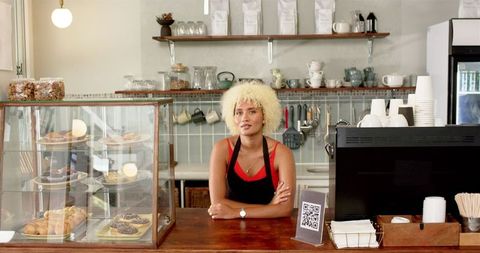 Friendly Young Barista Serving in Cozy Modern Cafe