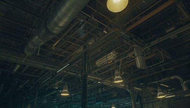 Overhead network of ducts and pipes in industrial facility