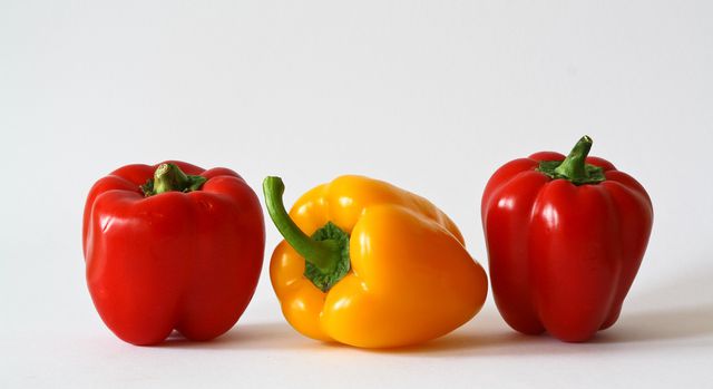 Bell peppers displayed against a white background emphasize vibrant colors and freshness. Ideal for use in recipes, food blogs, and promotional material for grocery stores, farmers markets, and dietary content. Perfect for healthy living or culinary articles.