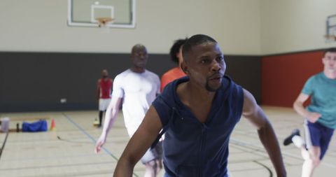Focused Basketball Team Training on Indoor Court
