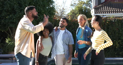 Happy Diverse Friends Laughing Near Pool in Bright Sunlight