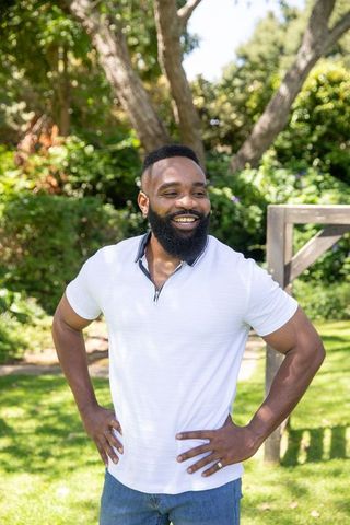 Smiling Man Enjoying Sunny Day in Garden