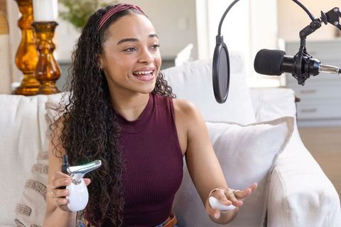 African american creator hosting home podcast demonstrating led skincare device and wipe