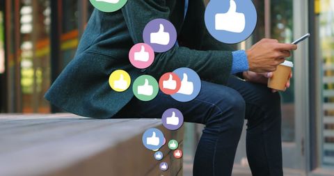 Man Engaging On Social Media With Phone In Urban Environment