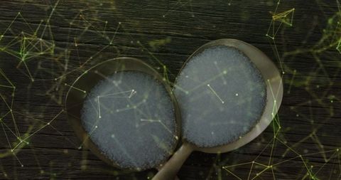 Two spoons of sugar enhancing culinary presentation with modern design overlay