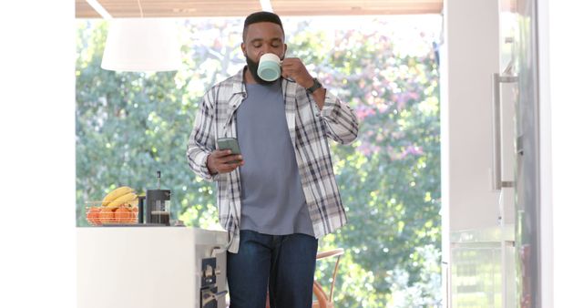 Relaxed Man Drinking Coffee and Checking Smartphone - Download Free Stock Images Pikwizard.com