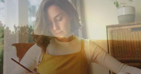 Artistic woman sketching with tranquil forest overlay