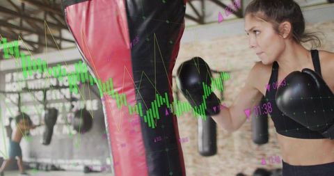 Female boxer training at gym with overlaid financial graph