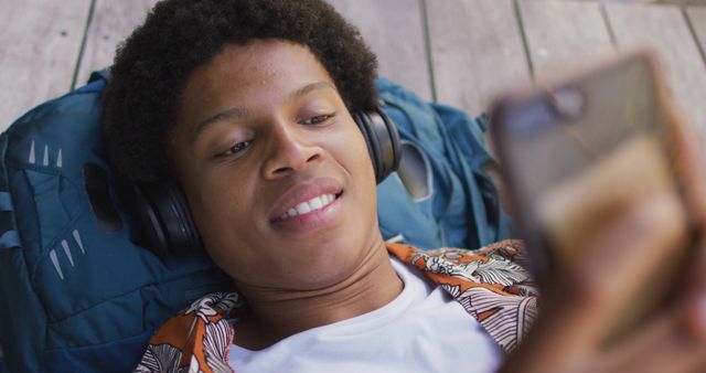 Young Person Relaxing with Headphones and Smartphone - Download Free Stock Images Pikwizard.com