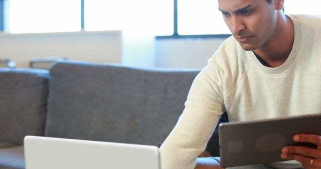 Man Using Laptop and Tablet Simultaneously for Work - Download Free Stock Images Pikwizard.com