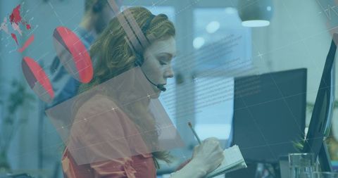 Businesswoman with Headset Taking Notes in Modern Office