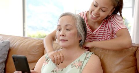 Asian Grandmother and Granddaughter Enjoying Time Together at Home