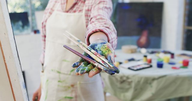 Artistic Hand Holding Brushes in Creative Studio - Download Free Stock Images Pikwizard.com