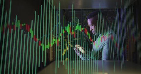 Technical environment highlights data analysis as an african american man uses a tablet surrounded by digital charts. Ideal for illustrating topics related to cloud computing, IT security, business intelligence, and the digital economy. Suitable for articles or presentations about technological advancements in data management and security sector innovation.