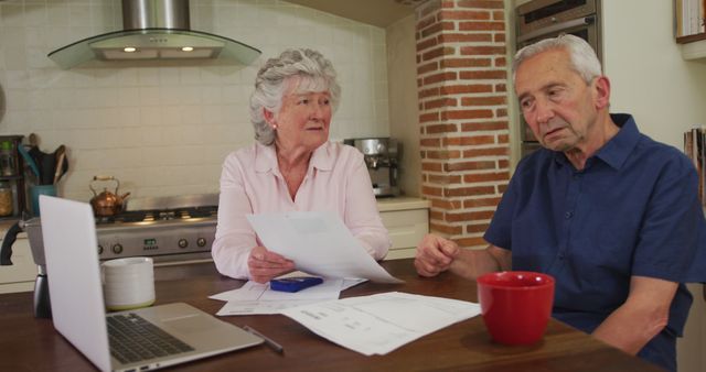Worried Senior Couple Discussing Finances at Kitchen Table - Download Free Stock Images Pikwizard.com