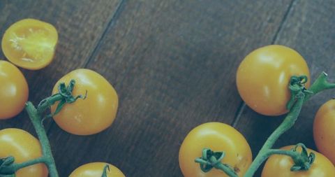 Organic Yellow Cherry Tomatoes on Rustic Wooden Surface