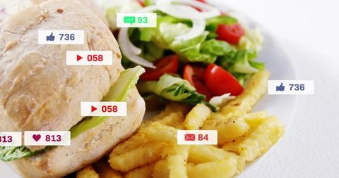 Rustic sandwich with crispy fries and fresh salad showing social media engagement icons