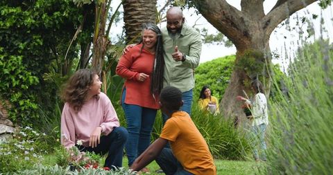Lively Multi-Generational Family Gardening Together Outdoors