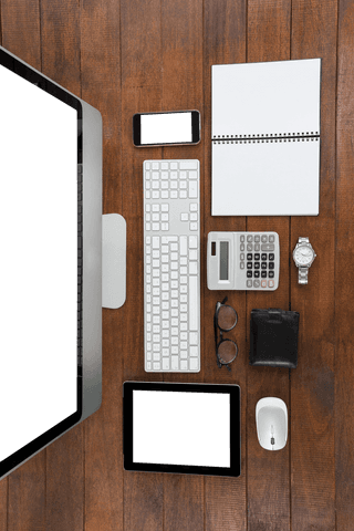 Top view wooden desk with transparent electronics and office belongings