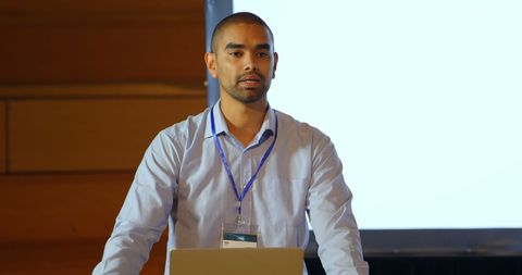 Confident Speaker Presenting Seminar on Modern Stage