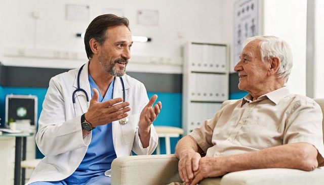 Doctor explaining treatment plan to senior patient during friendly medical consultation