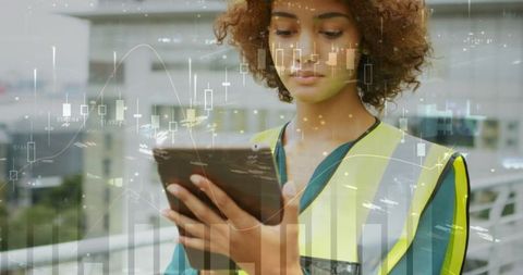 Female architect analyzing construction statistics on tablet
