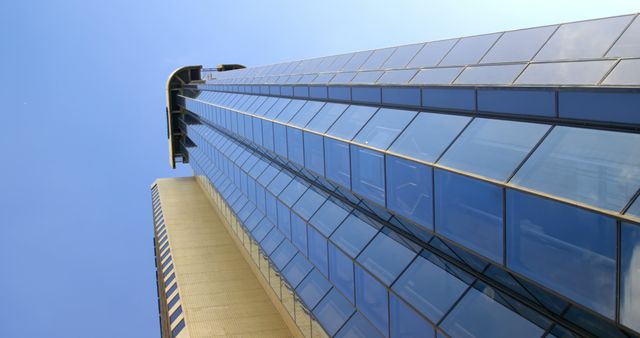 Modern Skyscraper with Glass Facade Against Clear Blue Sky - Download Free Stock Images Pikwizard.com