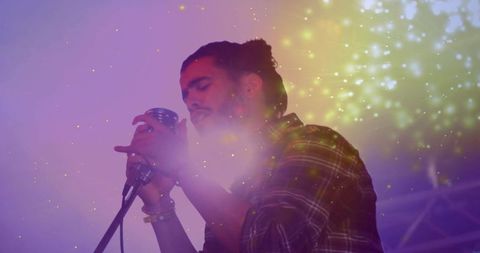 Moody indie singer with bun holding vintage microphone, neon haze and spark bokeh onstage