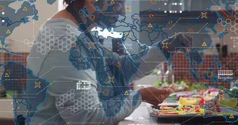 Senior Indian woman preparing healthy fruit platter in kitchen with global network overlay