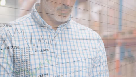 Businessman Analyzing Financial Graphs for Data Insights