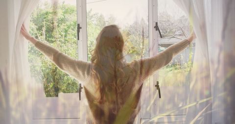 Woman Opening Curtains to Morning Light