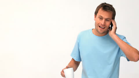 Cheerful Man Talking on Phone with Coffee Mug