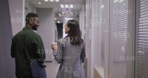 Business Colleagues Walking in Office with Holographic Data