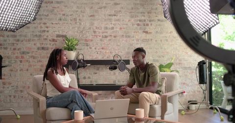 African American Co-Hosts Recording Casual Podcast Interview in Brick Studio with Soft Lighting